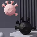 Pink coronavirus model and black bomb on a gray background